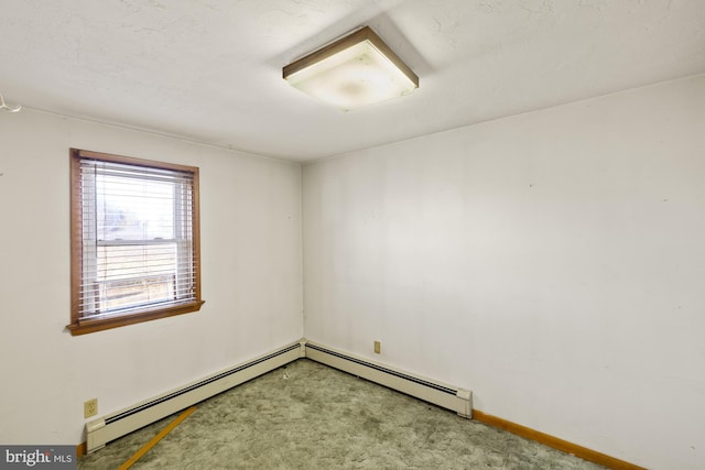 empty room featuring carpet floors and a baseboard heating unit