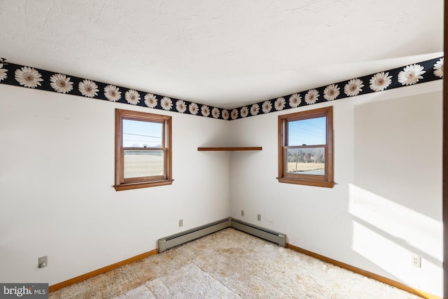 empty room with a baseboard radiator and a textured ceiling