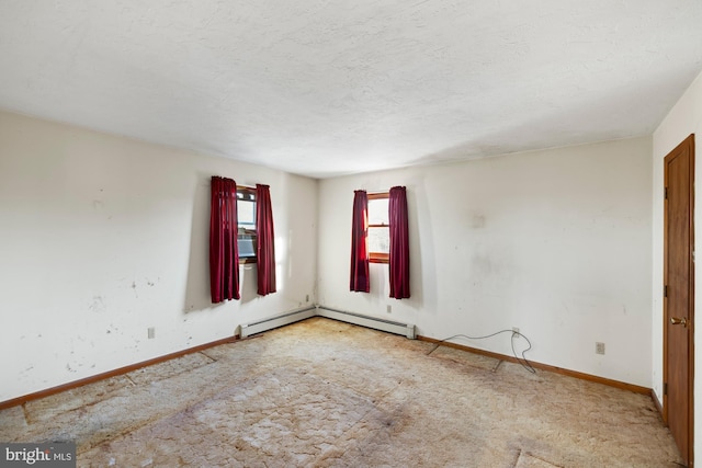 unfurnished room with a textured ceiling and a baseboard heating unit