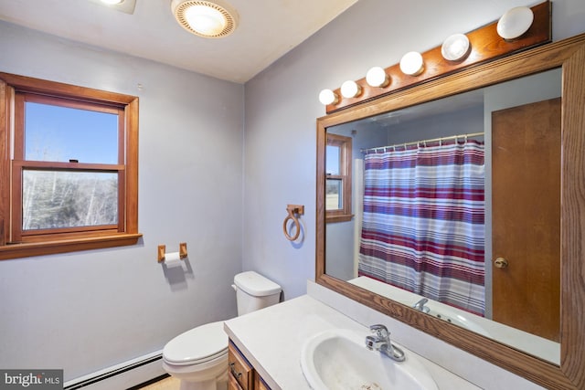 bathroom with a baseboard radiator, vanity, and toilet