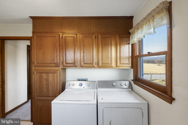 laundry area with cabinets, light carpet, and washer and clothes dryer