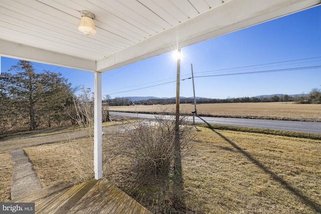 view of yard with a rural view