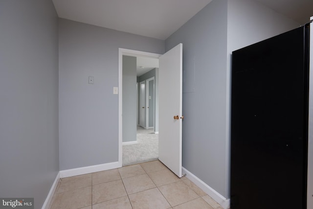 hall featuring light tile patterned flooring