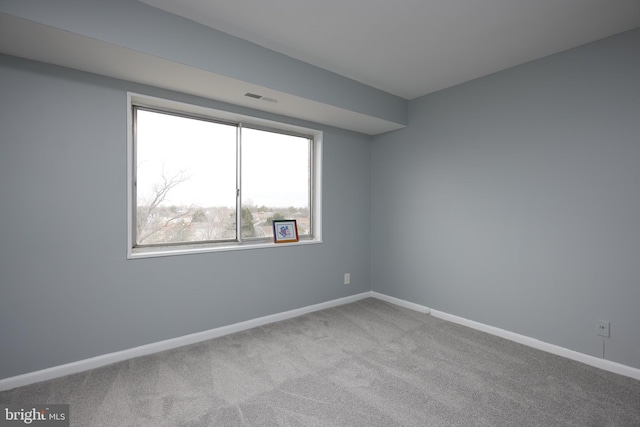 unfurnished room with light carpet