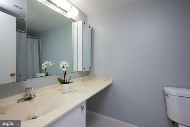 bathroom featuring vanity and toilet