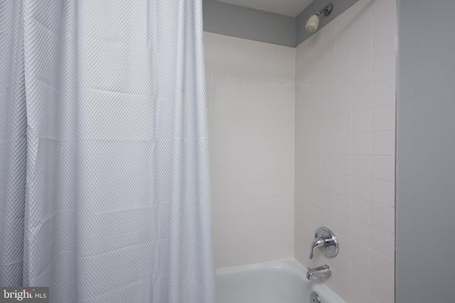 interior details featuring shower / bath combination with curtain