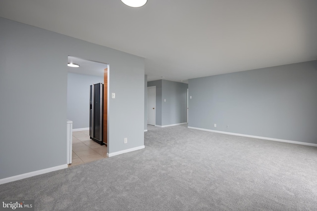 spare room featuring light colored carpet