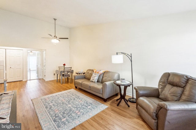 living area featuring light wood-style flooring and baseboards