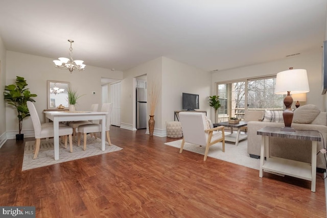 living room featuring hardwood / wood-style flooring and a notable chandelier