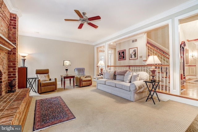 carpeted living room with ornamental molding and ceiling fan