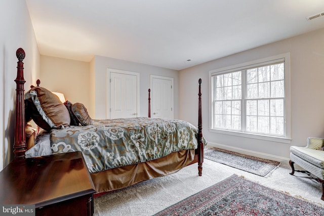 bedroom with visible vents, baseboards, and carpet