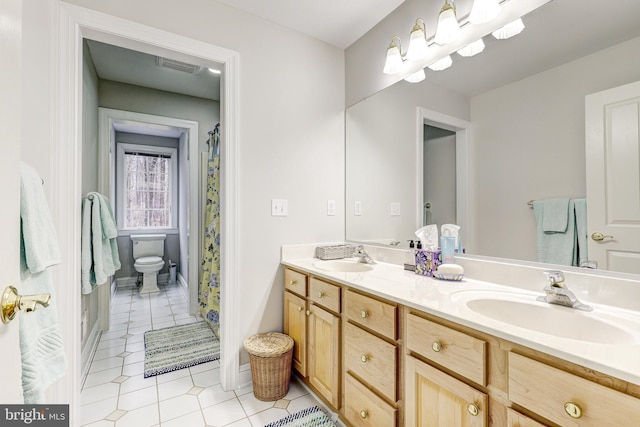 bathroom featuring a sink, visible vents, toilet, and double vanity