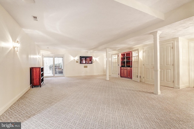 basement with baseboards, visible vents, and light carpet