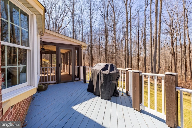 wooden deck with a sunroom