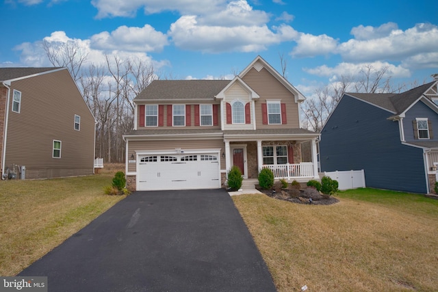 view of front of home featuring a porch, a garage, and a front lawn