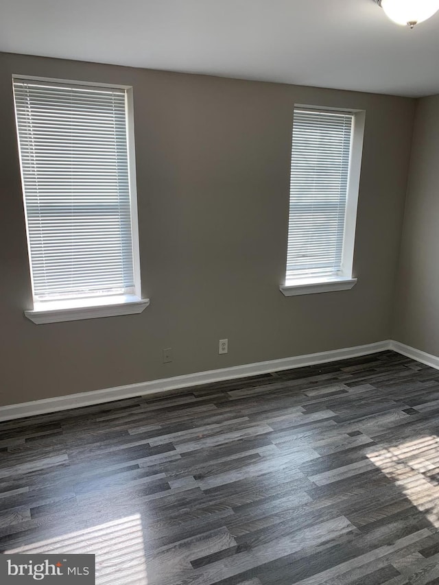 empty room with dark wood-type flooring