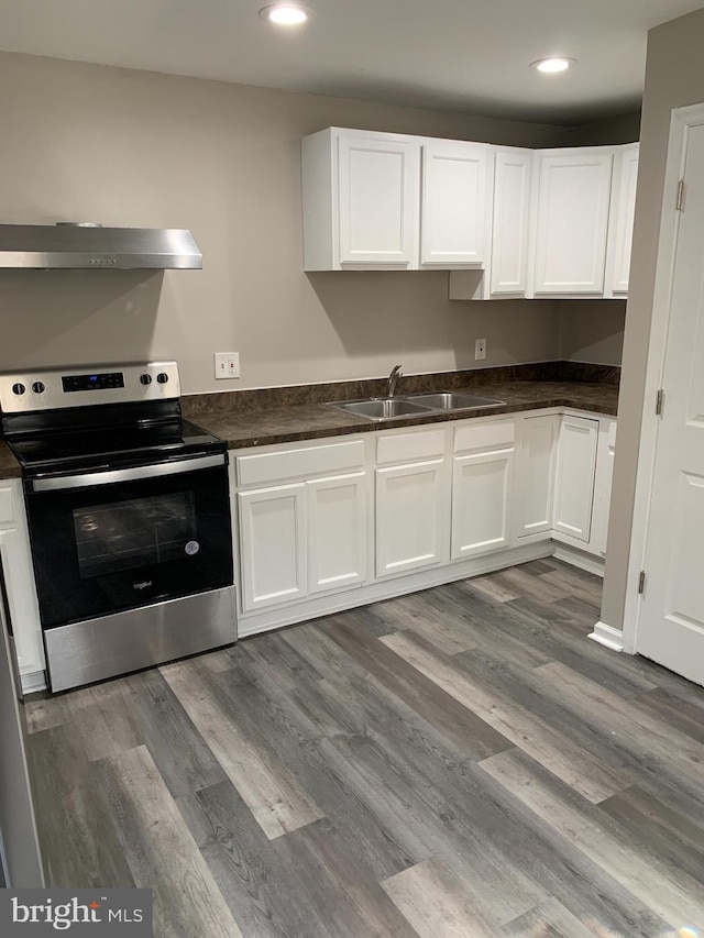 kitchen featuring white cabinetry and stainless steel electric range