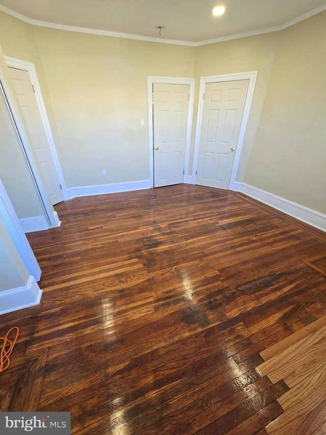 unfurnished bedroom with dark wood-type flooring and ornamental molding