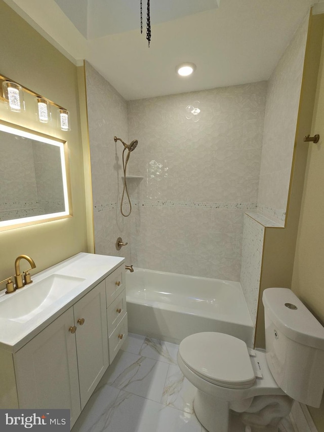 full bathroom featuring vanity, tiled shower / bath, and toilet