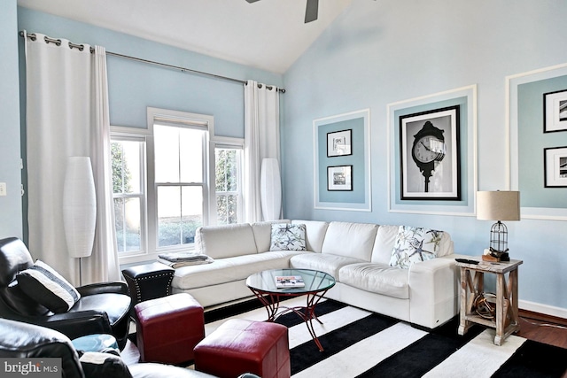 living room featuring hardwood / wood-style flooring, vaulted ceiling, and ceiling fan