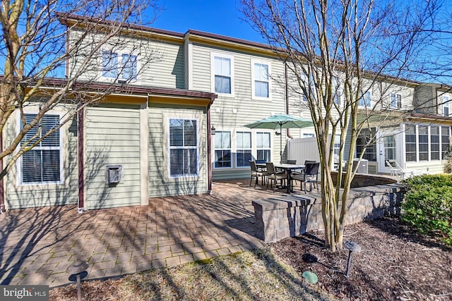 rear view of property featuring a patio area