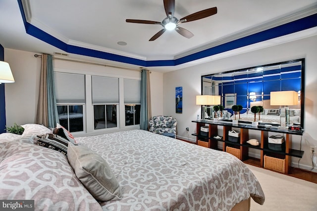 bedroom featuring crown molding, ceiling fan, and a raised ceiling