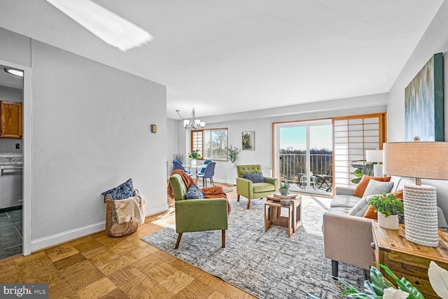 living room with a chandelier and light parquet floors