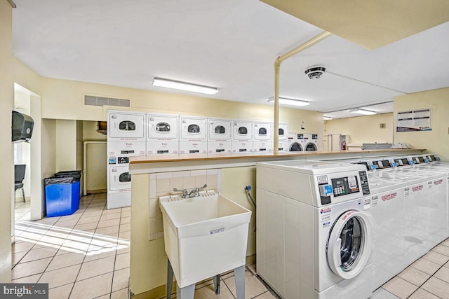 washroom featuring light tile patterned flooring, stacked washer and dryer, separate washer and dryer, and sink