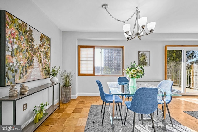 dining area featuring an inviting chandelier and light parquet floors