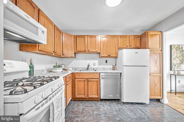 kitchen featuring white appliances and sink