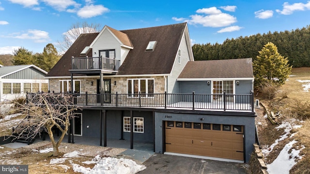 view of front of house featuring a garage and a balcony