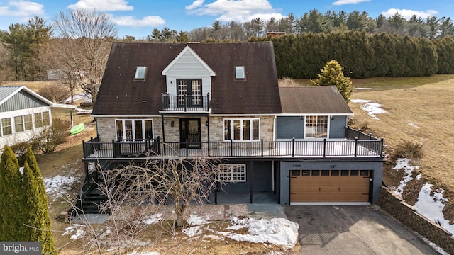 view of front of home featuring a balcony, a garage, and a deck