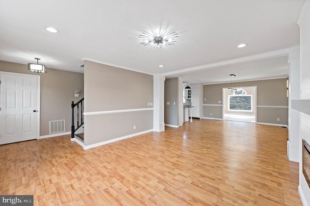 unfurnished living room featuring crown molding and light wood-type flooring