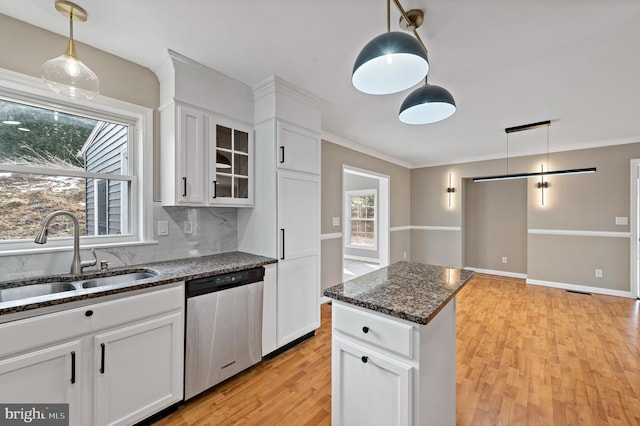 kitchen featuring sink, white cabinetry, hanging light fixtures, dark stone countertops, and dishwasher