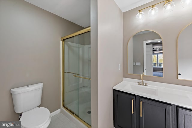 bathroom with an enclosed shower, vanity, tile patterned flooring, and toilet