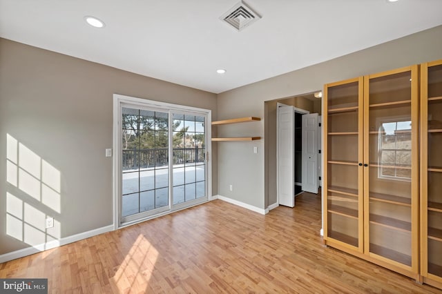 unfurnished room with hardwood / wood-style flooring