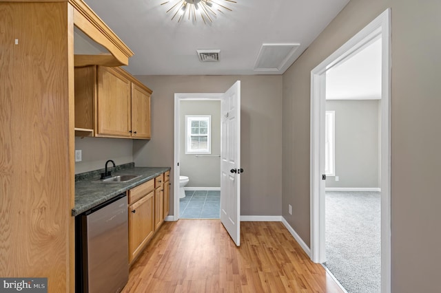 kitchen with light brown cabinetry, sink, dishwasher, and light wood-type flooring