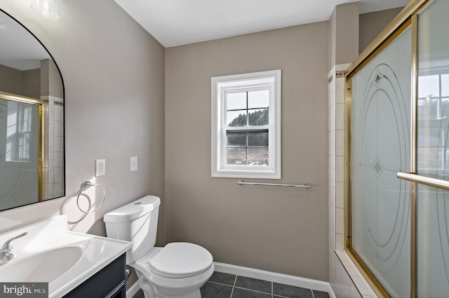 bathroom featuring tile patterned floors, toilet, a shower with door, and vanity