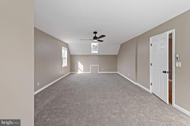 interior space with ceiling fan, lofted ceiling, and carpet