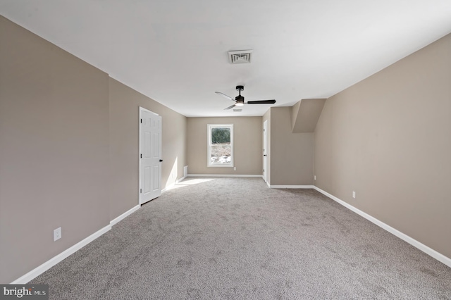 interior space with light carpet and ceiling fan