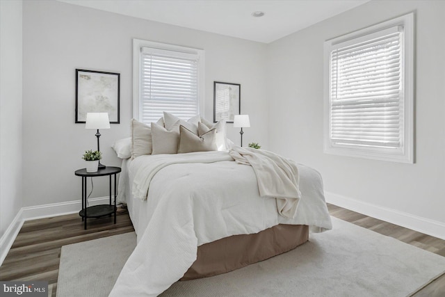 bedroom with dark wood-type flooring