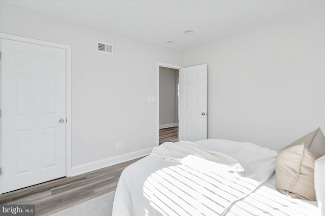 bedroom with wood-type flooring