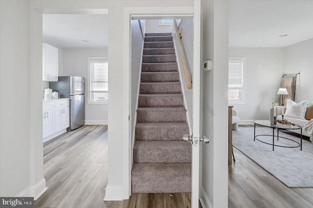 staircase with hardwood / wood-style floors