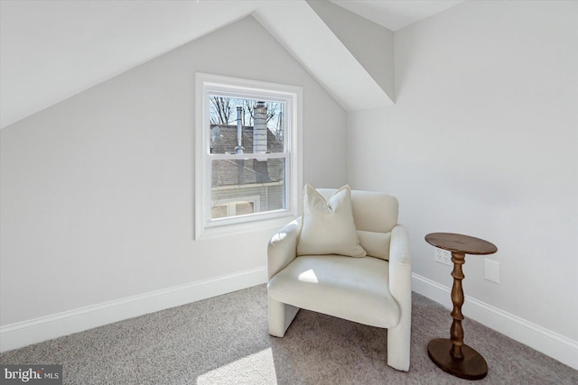 living area with carpet floors and vaulted ceiling