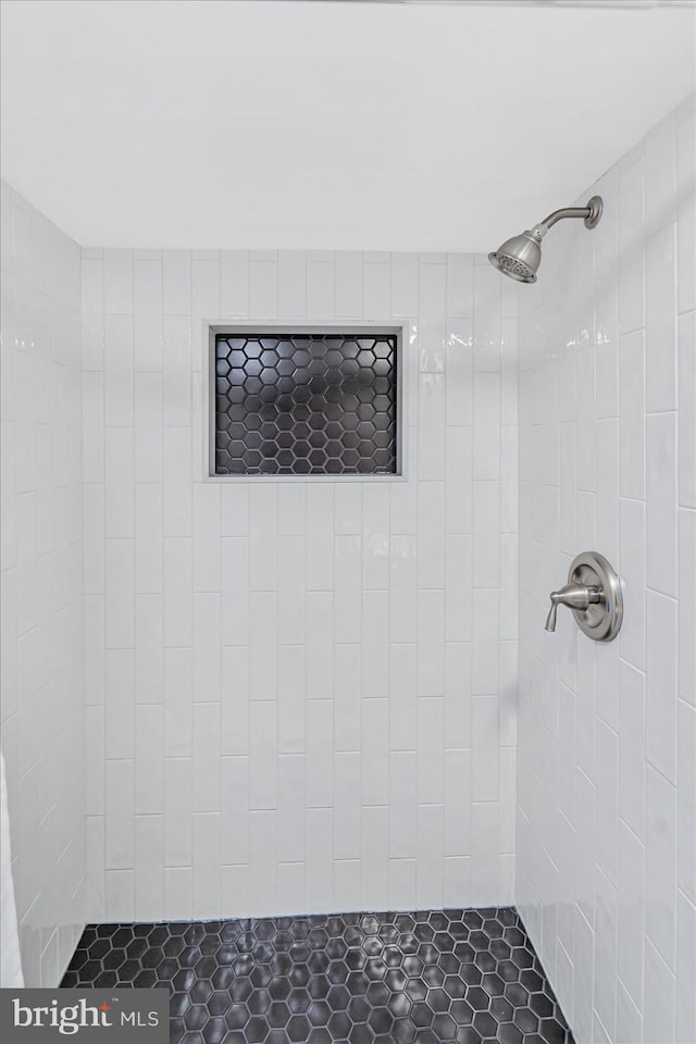 bathroom with tiled shower