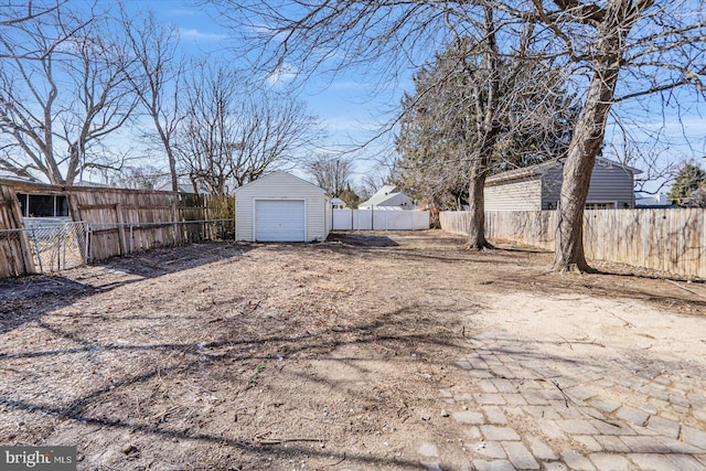 view of yard with a garage and an outdoor structure