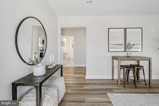 hallway with light hardwood / wood-style floors