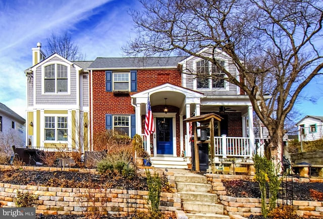 view of front of property with brick siding, a porch, and a chimney