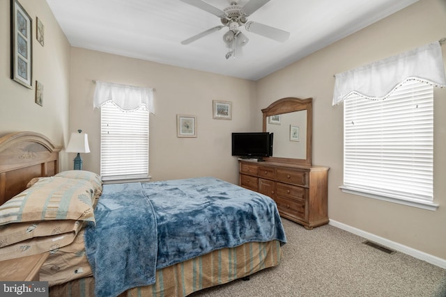 bedroom with ceiling fan and light colored carpet