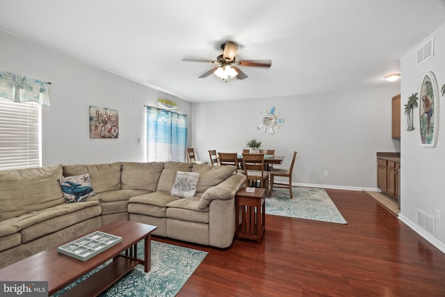 living room featuring dark hardwood / wood-style floors and ceiling fan